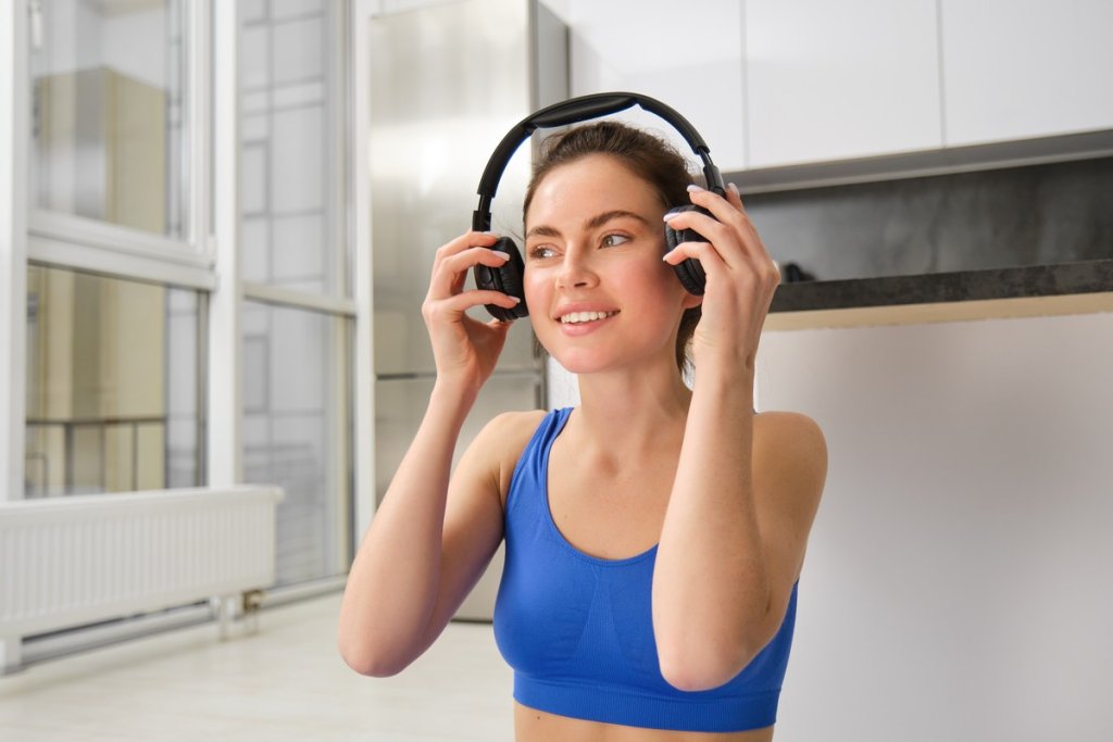 image-young-fitness-girl-wearing-blue-tracksuit-puts-wireless-headphones-workout-with-music.jpg