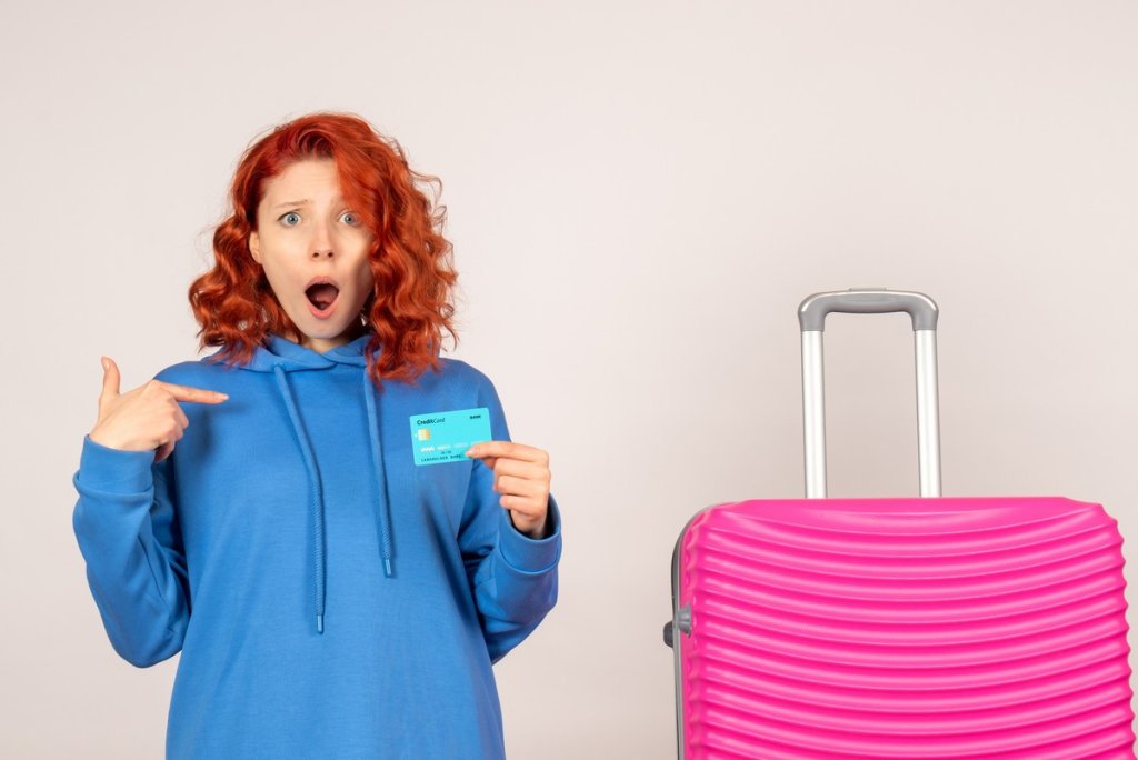 front-view-female-tourist-with-pink-bag-holding-bank-card.jpg