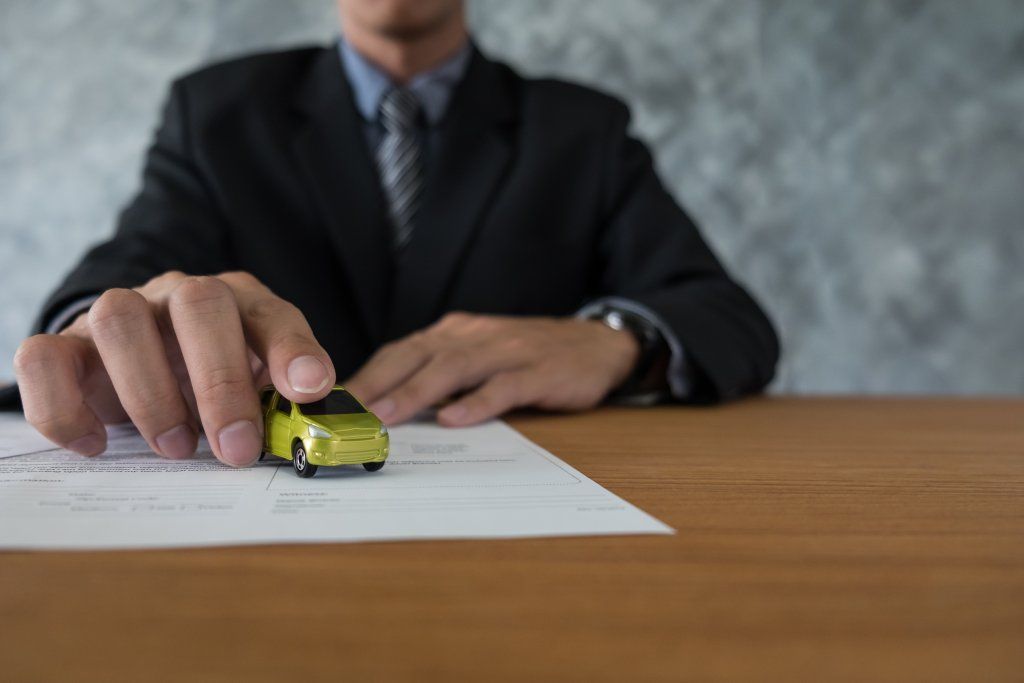 transportation-and-ownership-concept-customer-and-salesman-with-car-key.jpg