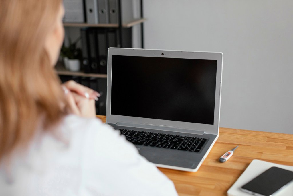 close-up-doctor-checking-patient-with-laptop.jpg